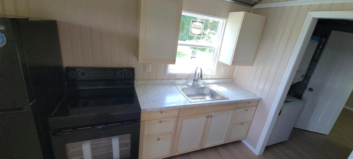 Homestead refrigerator, range and kitchen cabinetry